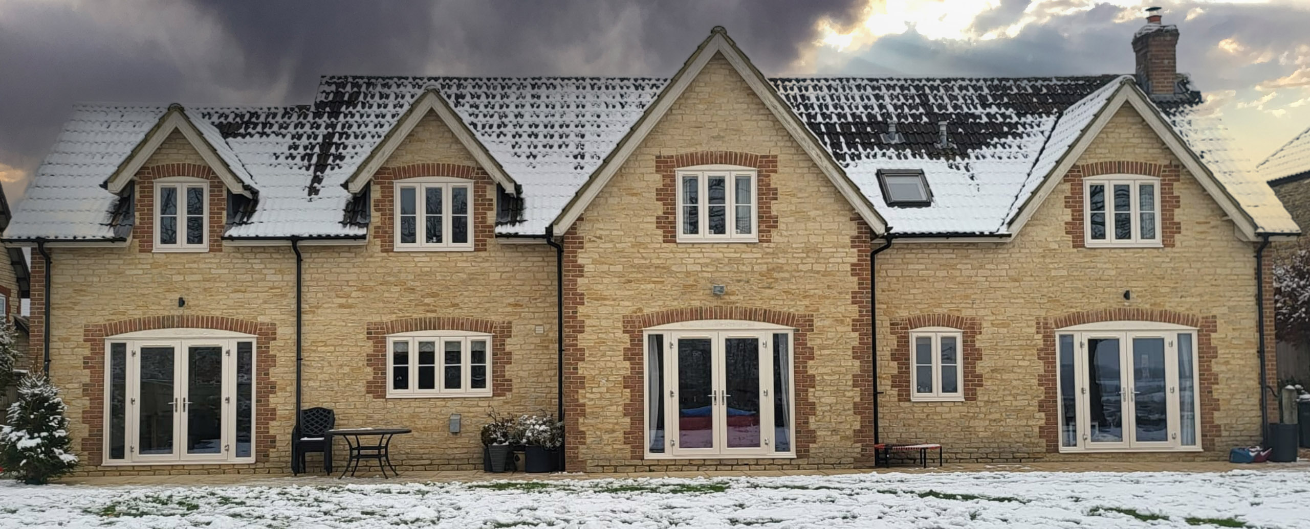 photo of a snow capped house with casement windows