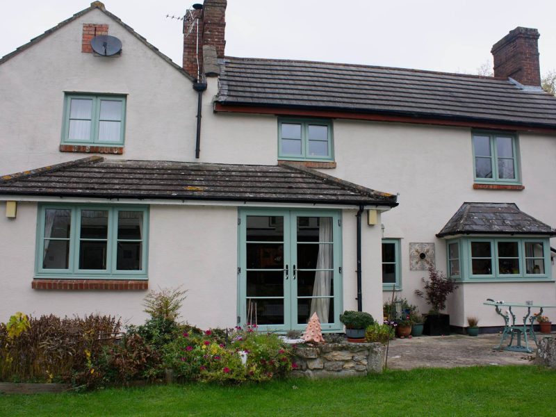 large white house with green doors and windows