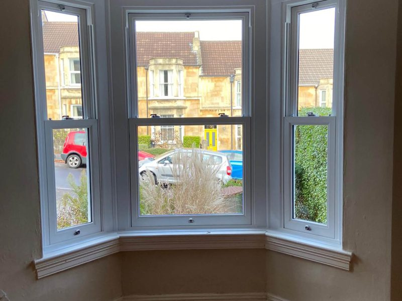 indoor view of white bay windows