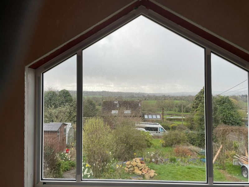 large window with a view of the countryside