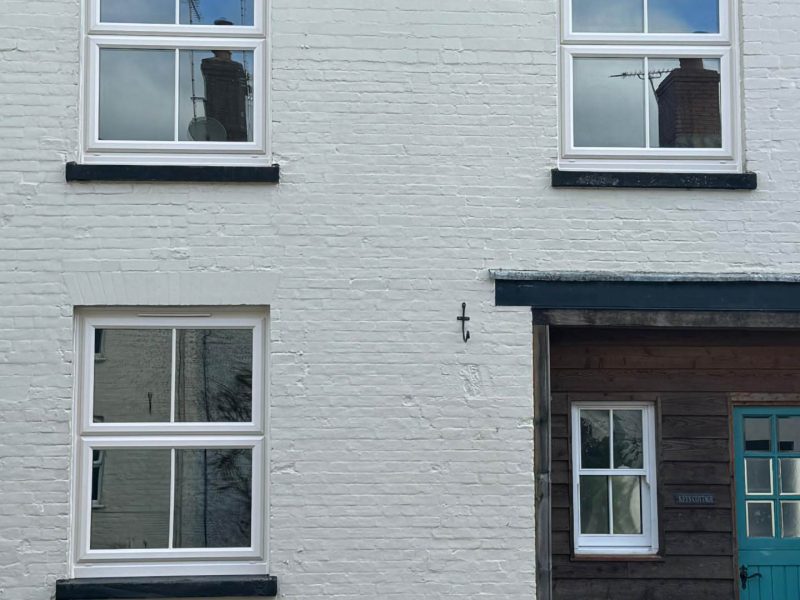 white windows and a green front door