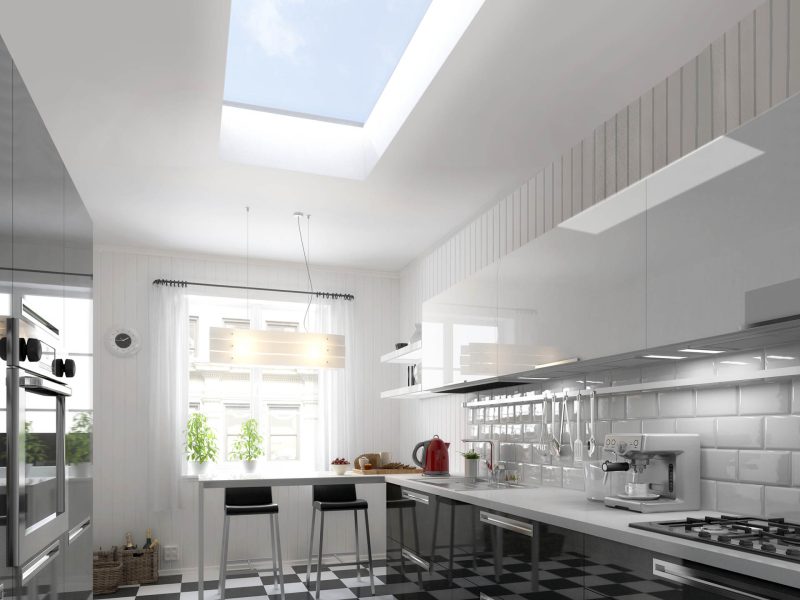 interior view of a kitchen with a chequered floor and roof window